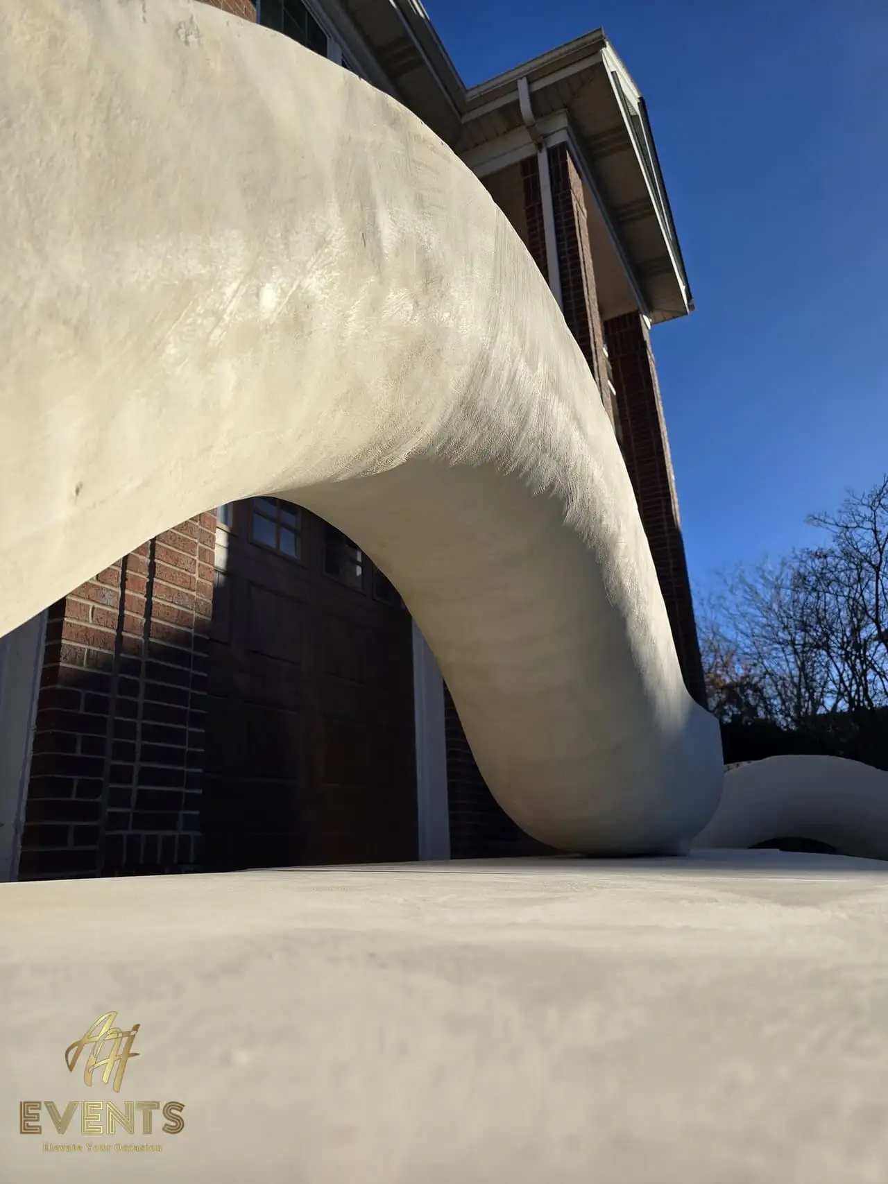 Classical Pillar Arch & Stage — a custom arch & contoured stage built by AH Crafted.