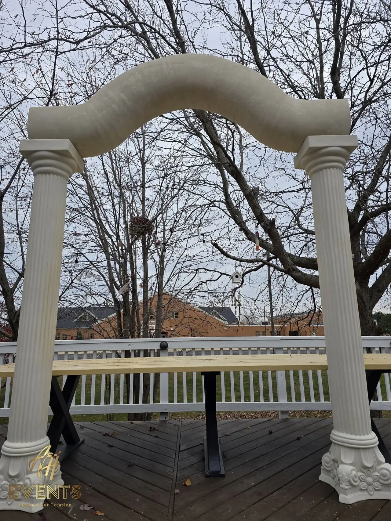 Classical Pillar Arch & Stage — a custom arch & contoured stage built by AH Crafted.
