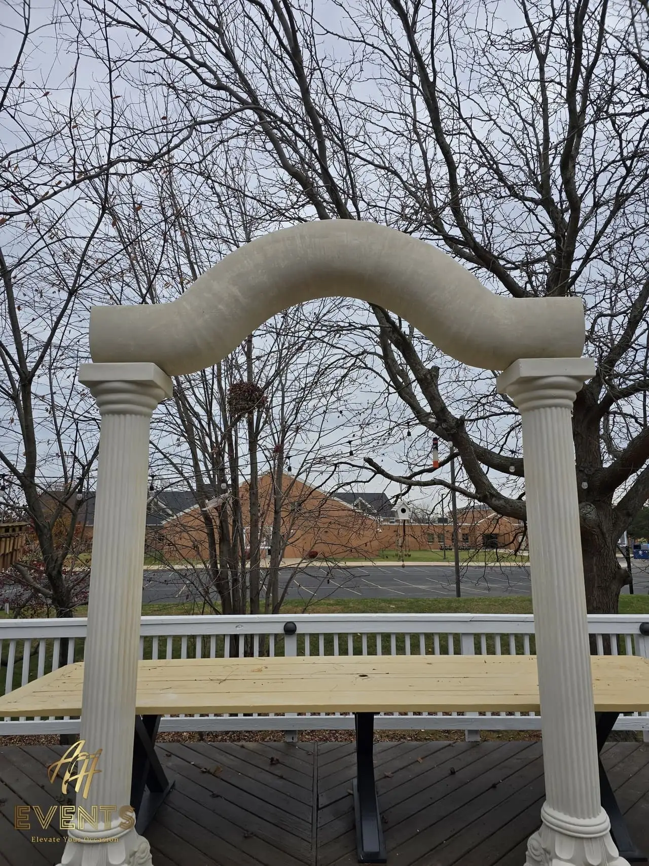 Classical Pillar Arch & Stage — a custom arch & contoured stage built by AH Crafted.