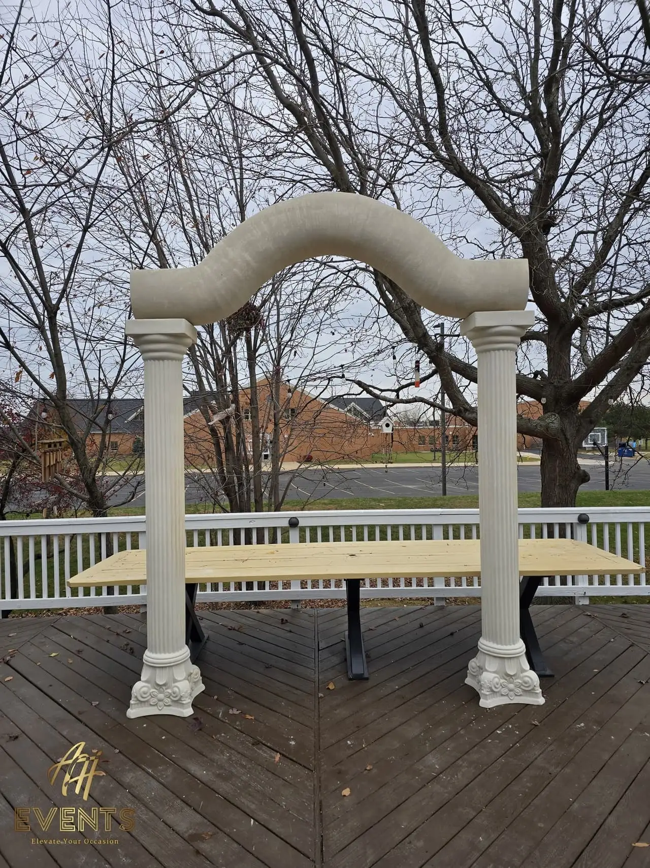 Classical Pillar Arch & Stage — a custom arch & contoured stage built by AH Crafted.
